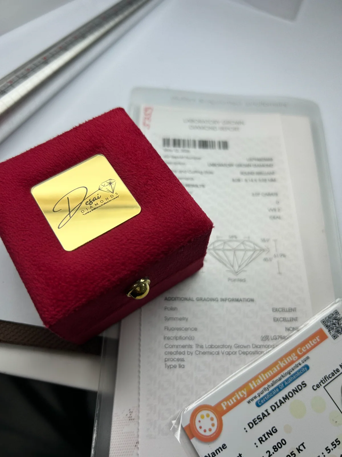 Desai Diamonds presentation box with an IGI grading report and hallmarking documentation